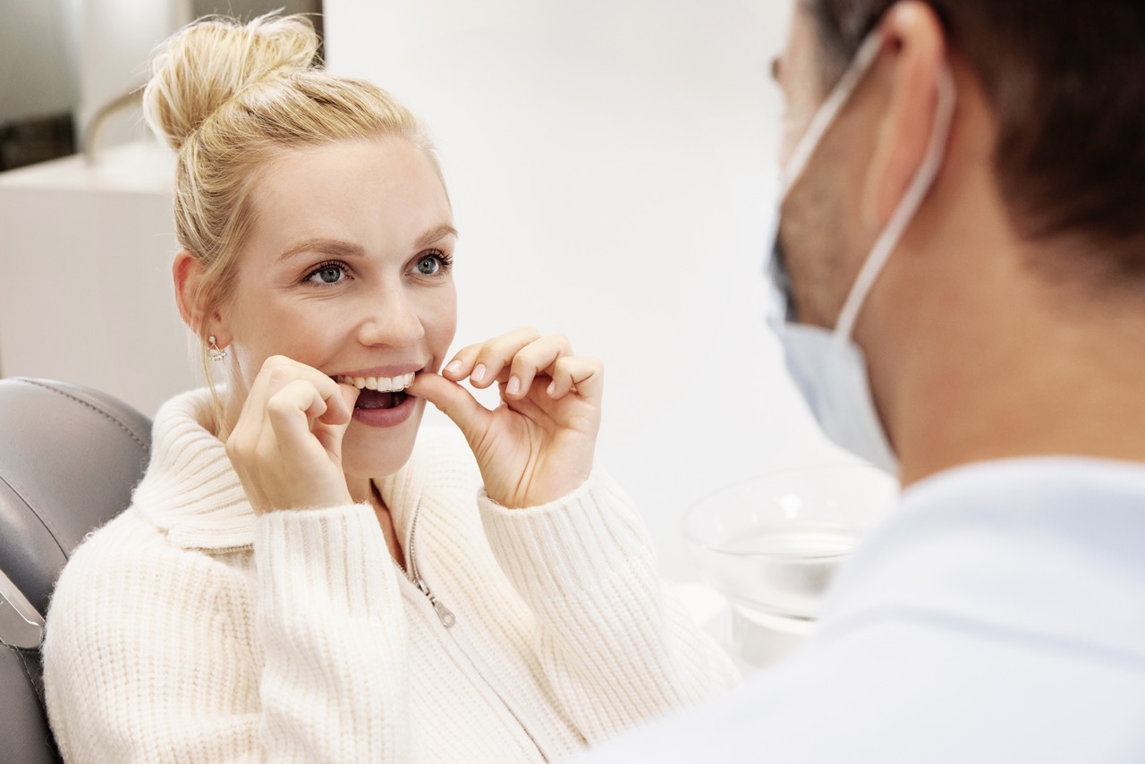 Clinician showing a patient their Spark™ treatment progress — Spark brand photography